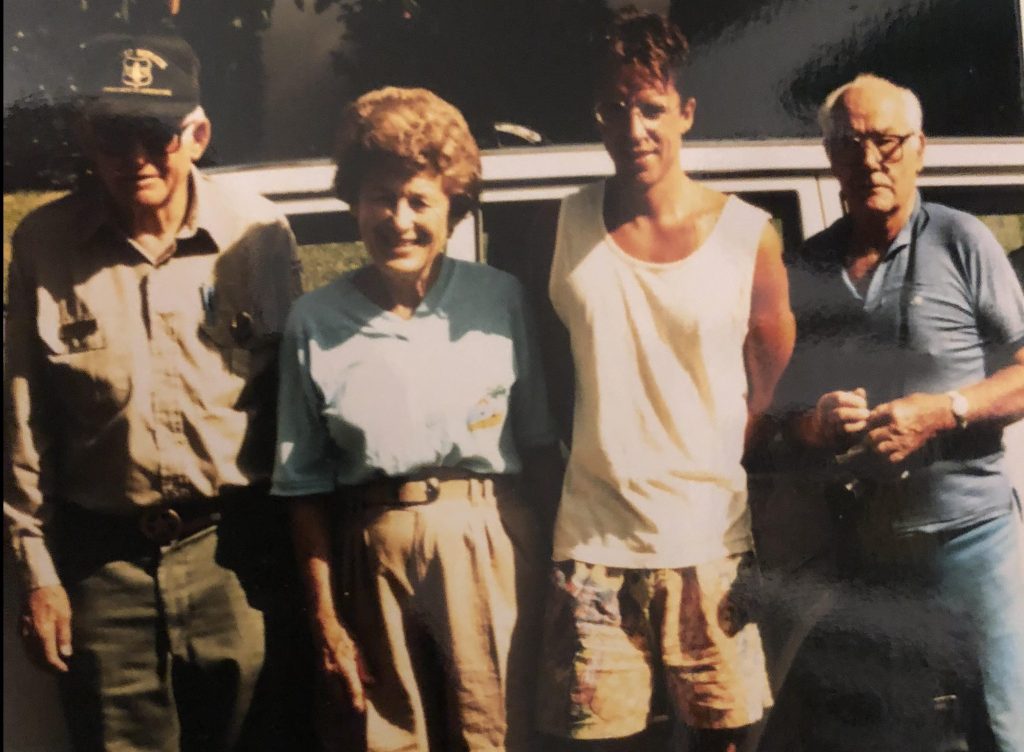 Four friends pose for photo in front of car. Taken in 1991