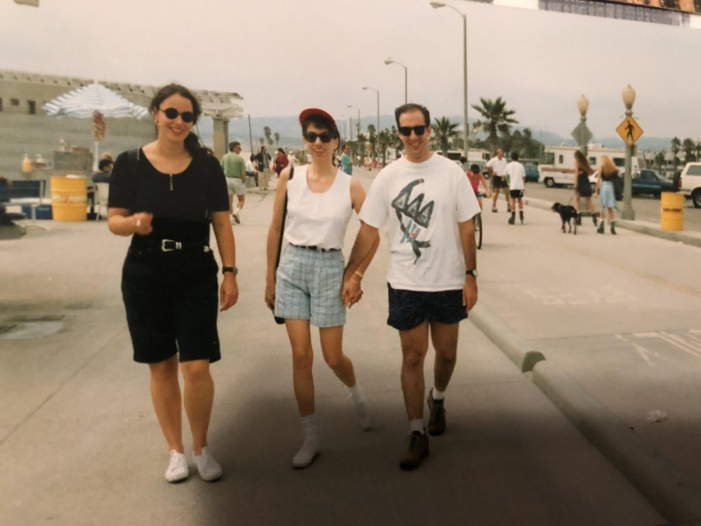 three friends walk along a sunny California street. Picture taken in 1993